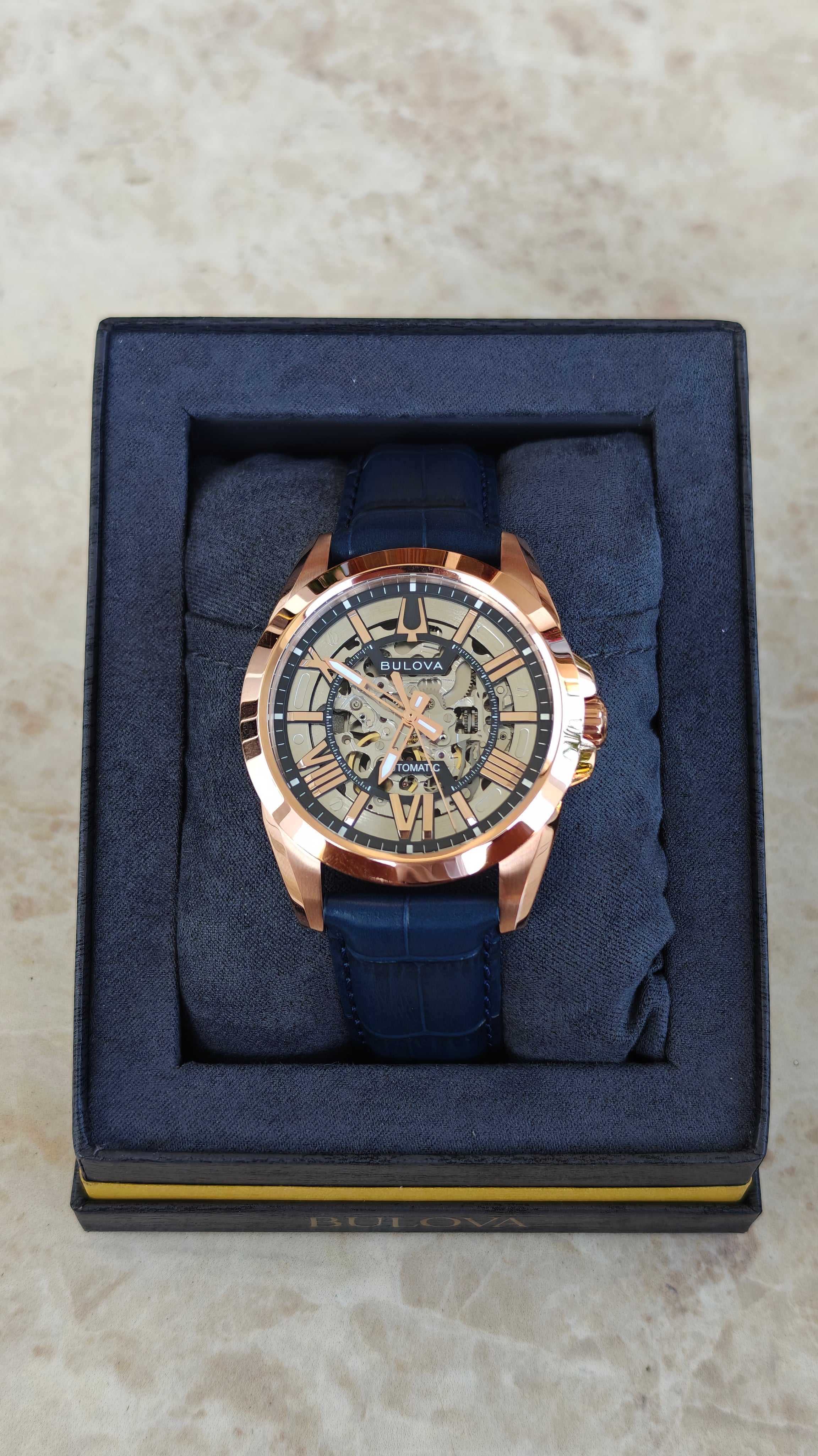Bulova Sutton 97A161 – Automatic Skeleton Rose Gold & Blue