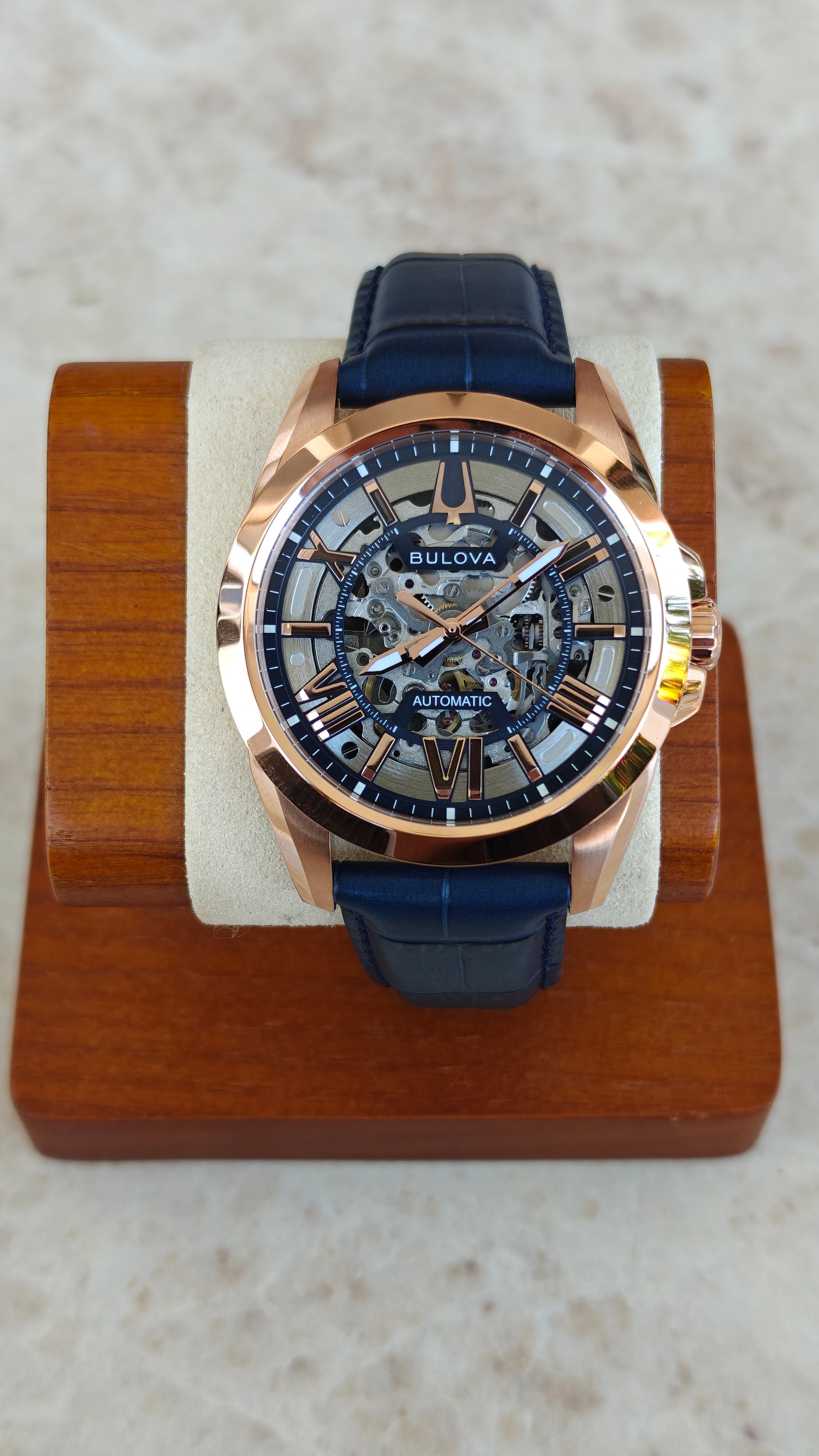 Bulova Sutton 97A161 – Automatic Skeleton Rose Gold & Blue
