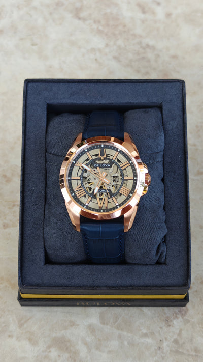 Bulova Sutton 97A161 – Automatic Skeleton Rose Gold & Blue